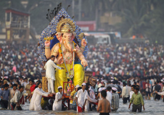 Devotees carry an idol of the Hindu elephant god Ganesh for immersion into the Arabian Sea on the last day of the Ganesh Chaturthi festival in Mumbai