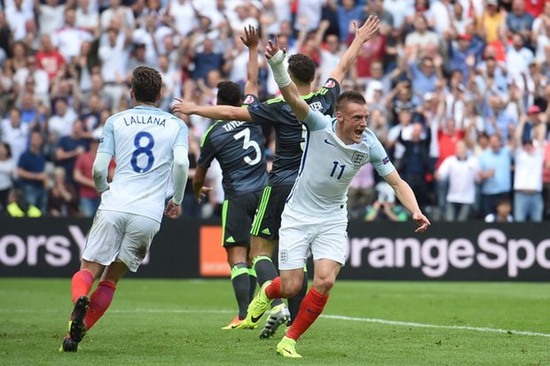 Jamie Vardy races away to celebrate the equalizer as Welsh players appeal for offside
