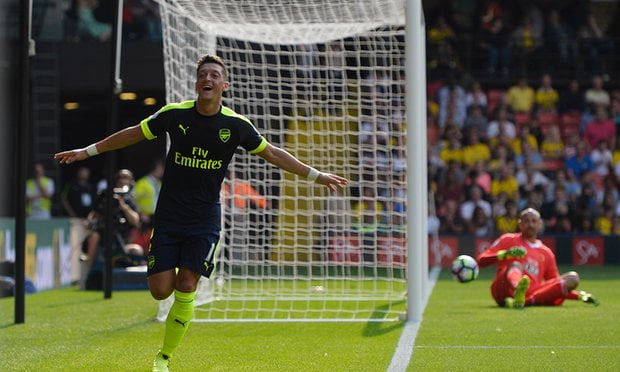 Mesut Ozil wheels away in celebration after scoring against Watford.