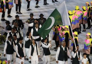 Ghulam Mustafa Bashir carries the flag of Pakistan during the opening ceremony for the 2016 Summer Olympics in Rio de Janeiro, Brazil, Friday, Aug. 5, 2016. (AP Photo/Patrick Semansky)