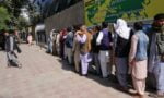 People wait outside a bank to withdraw cash on 16th August after the Taliban’s takeover of Kabul. Queues can stretch for hundreds of metres