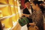 A woman shops in a Louis Vuitton store during Vogue’s 4th Fashion’s Night Out: Shopping Night with Celebrities in downtown Shanghai