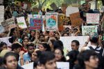 Students and activists hold placards with messages as they participate in a Global Climate Strike rally in New Delhi